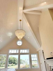 vf builders exposed beam vaulted ceiling with plank board and multiple bay windows