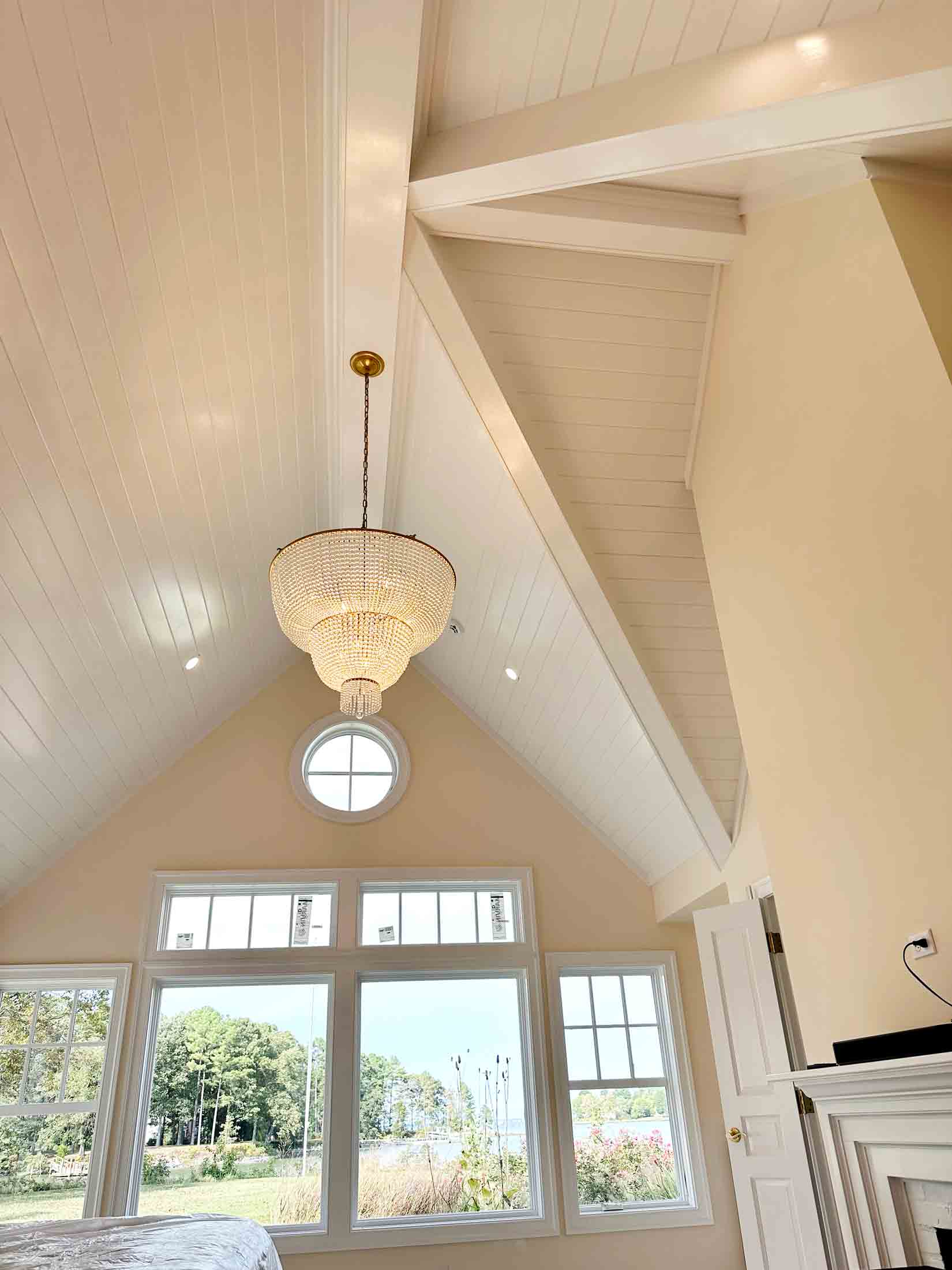 vf builders exposed beam vaulted ceiling with plank board and multiple bay windows