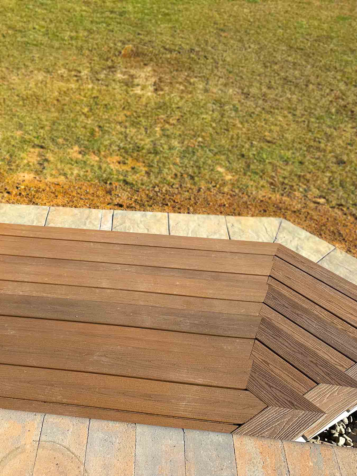 Exterior steps with composite decking, masonry tile border