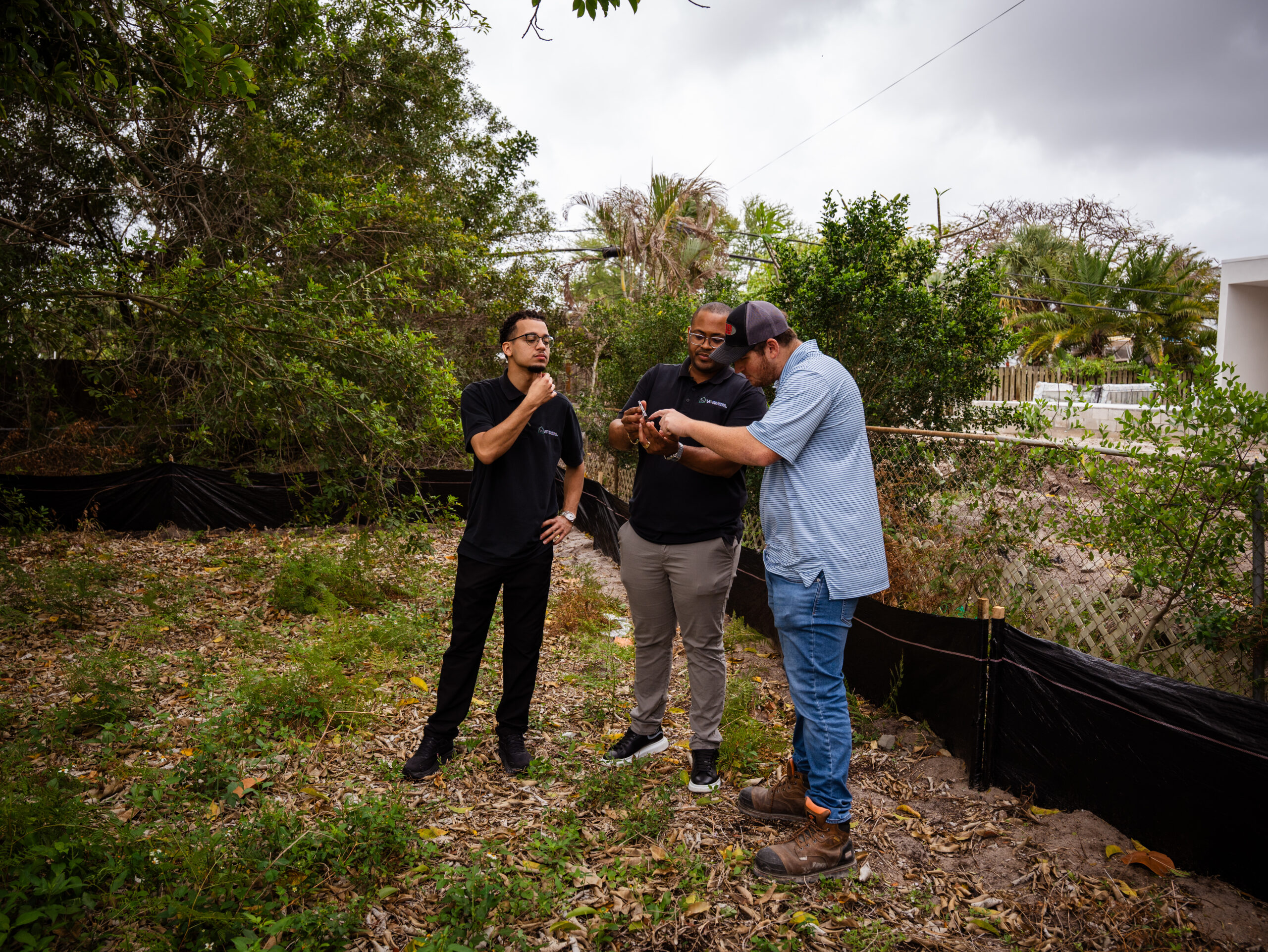 Vinicius Ferreira reviewing a residential lot with clients in Delray Beach